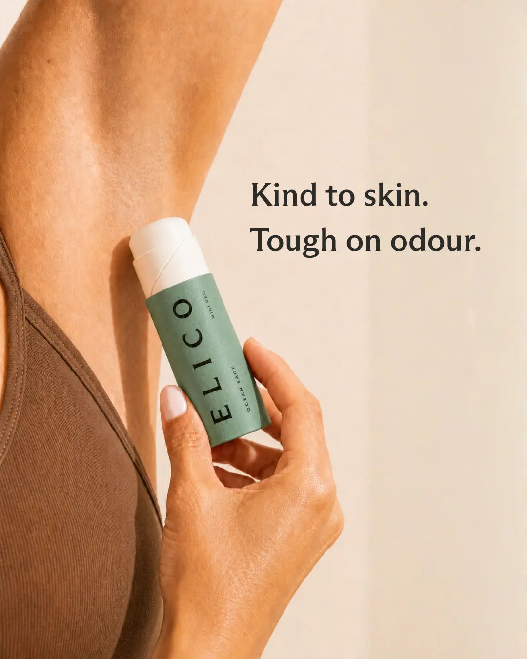 Hand holding an opened Mini Deo Ocean & Sage up to the underarm